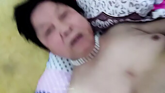 An Older Asian Woman Engages In Sexual Intercourse